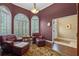 Comfortable living room with leather chairs, ottoman, shuttered windows, and hardwood floors at 1921 Redwood Grove, Lake Mary, FL 32746