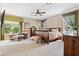 Serene main bedroom with ceiling fan, cozy seating, and natural light from large windows at 1921 Redwood Grove, Lake Mary, FL 32746