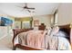 Serene main bedroom boasts natural light, ceiling fan, and comfortable furnishings at 1921 Redwood Grove, Lake Mary, FL 32746