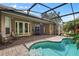 Inviting screened patio with outdoor seating, ceiling fan, and access to the pool at 1921 Redwood Grove, Lake Mary, FL 32746