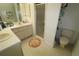 Well-lit bathroom with double sinks, stand up shower and plenty of storage space at 201 Clusterwood Dr, Yalaha, FL 34797