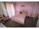 Charming pink bedroom with lots of toys, natural light, and a cozy feel at 201 Clusterwood Dr, Yalaha, FL 34797