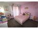 Charming pink bedroom with lots of toys, natural light, and a cozy feel at 201 Clusterwood Dr, Yalaha, FL 34797