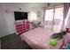 Bright bedroom with pink decor, large window, and plenty of storage at 201 Clusterwood Dr, Yalaha, FL 34797