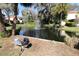 Pond with fountain and landscaped surrounding area at 201 Clusterwood Dr, Yalaha, FL 34797