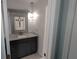 Charming bathroom featuring a gray vanity with marble countertop and stylish mirror at 210 Dartmouth St, Deltona, FL 32725