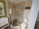 A bright bathroom featuring glass-enclosed shower, neutral walls, and modern fixtures at 210 Dartmouth St, Deltona, FL 32725