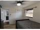 This bedroom features a ceiling fan, window with blinds, wood look floors, and a closet at 210 Dartmouth St, Deltona, FL 32725