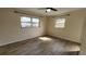 A bright bedroom featuring sleek floors, neutral walls, and two large windows allowing in an abundance of light at 210 Dartmouth St, Deltona, FL 32725