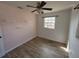 Cozy bedroom featuring fresh paint, tile floors, and a ceiling fan at 210 Dartmouth St, Deltona, FL 32725