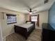 Bedroom featuring a ceiling fan, wood-look flooring, a window and a bed at 210 Dartmouth St, Deltona, FL 32725