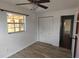 A bright bedroom featuring sleek floors, neutral walls, a large closet, and a window allowing in natural light at 210 Dartmouth St, Deltona, FL 32725