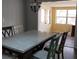 A bright dining room features a modern chandelier, sleek floors, and a large table perfect for gatherings at 210 Dartmouth St, Deltona, FL 32725