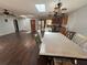Open dining area with wood floors, skylight, and a view into the kitchen at 210 Dartmouth St, Deltona, FL 32725