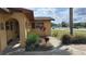 Lush landscaping surrounds this home's walkway, leading to a charming entrance with arched accents at 210 Dartmouth St, Deltona, FL 32725