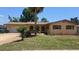 Charming single-story home with a well-maintained lawn and mature landscaping, complemented by a beautiful palm tree at 210 Dartmouth St, Deltona, FL 32725