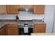 Updated kitchen featuring stainless steel oven, subway tile backsplash, and wood cabinets at 210 Dartmouth St, Deltona, FL 32725