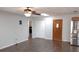 Open living room with wood floors, natural light, and stainless steel refrigerator and freezer at 210 Dartmouth St, Deltona, FL 32725