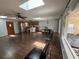 Open-concept living space featuring hardwood floors, modern lighting, and a seamless flow to the dining area at 210 Dartmouth St, Deltona, FL 32725