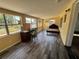 Bright sunroom featuring large windows, wood-look tile flooring, and ample space for relaxation and entertainment at 210 Dartmouth St, Deltona, FL 32725