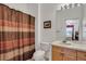 Bathroom featuring a vanity with a sink, a toilet, and a bathtub with a shower curtain at 2305 Butterfly Palm # 102, Kissimmee, FL 34747