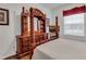 A large wooden dresser dominates this bedroom featuring hardwood floors and a large window at 2305 Butterfly Palm # 102, Kissimmee, FL 34747