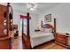 Well-lit bedroom featuring a bed, ceiling fan, and a dresser with a TV at 2305 Butterfly Palm # 102, Kissimmee, FL 34747