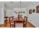 Dining room with hardwood floors, decorative chandelier, and seating for six at 2305 Butterfly Palm # 102, Kissimmee, FL 34747