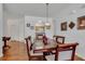 Dining room with hardwood floors, decorative chandelier, and seating for six at 2305 Butterfly Palm # 102, Kissimmee, FL 34747