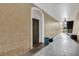 Hallway view of unit 102 featuring textured walls and tiled floors at 2305 Butterfly Palm # 102, Kissimmee, FL 34747