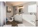 Well-lit bathroom featuring a white vanity, bathtub, and unique tile flooring at 2405 Abalone Blvd, Orlando, FL 32833