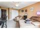 Tan bedroom featuring carpeted floor, white closet doors, and a modern ceiling fan at 2405 Abalone Blvd, Orlando, FL 32833