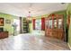 Bright living room featuring wood-look tile floors, unique decor and an ornate wooden cabinet with glass doors at 2405 Abalone Blvd, Orlando, FL 32833