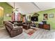 Spacious living room featuring vaulted ceilings, a plush sofa, and abundant natural light through a large window at 2405 Abalone Blvd, Orlando, FL 32833