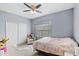 Cozy bedroom features natural light, ceiling fan and closet, perfect for relaxation at 2537 Rock Pl, Poinciana, FL 34759