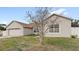 Exterior shot of single-story home with a driveway and attached garage at 2537 Rock Pl, Poinciana, FL 34759