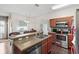 Functional kitchen with stainless steel appliances, double sink and adjacent dining area at 2537 Rock Pl, Poinciana, FL 34759