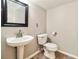 Simple bathroom featuring a pedestal sink, toilet, and a framed mirror at 259 Westchester Dr, Deland, FL 32724