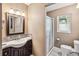 Cozy bathroom featuring a vanity with dark wood cabinets and a shower with sliding glass doors at 259 Westchester Dr, Deland, FL 32724