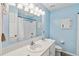 Bathroom featuring double sinks and a large mirror over the vanity, with a shower in the background at 259 Westchester Dr, Deland, FL 32724