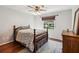 Comfortable bedroom with hardwood floors, a ceiling fan, and a wooden bed frame at 259 Westchester Dr, Deland, FL 32724