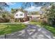 Beautiful two-story home with lush landscaping and a well-maintained lawn and driveway, showcasing curb appeal at 259 Westchester Dr, Deland, FL 32724