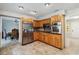 Open kitchen featuring stainless steel appliances and tile flooring that leads into a dining space at 259 Westchester Dr, Deland, FL 32724