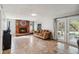 Cozy living room featuring a brick fireplace, tile flooring, and natural light from windows and glass doors at 259 Westchester Dr, Deland, FL 32724