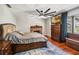 Bedroom with a brick fireplace, a large flat-screen TV, and a bay window that provides natural light at 259 Westchester Dr, Deland, FL 32724