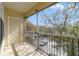 Enclosed patio with metal railing and a screen overlooking a tree-lined street at 2624 Robert Trent Jones Dr # 634, Orlando, FL 32835