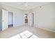 Bright bedroom featuring neutral carpet, light gray walls and a ceiling fan at 2624 Robert Trent Jones Dr # 634, Orlando, FL 32835