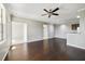 Open-concept living area with hardwood floors, a ceiling fan, and neutral walls leading into a dining area at 2624 Robert Trent Jones Dr # 634, Orlando, FL 32835