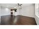 Living room with hardwood floors, neutral walls, a ceiling fan, and a partial view of the kitchen area at 2624 Robert Trent Jones Dr # 634, Orlando, FL 32835