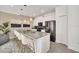 Modern kitchen with stainless steel appliances, a large island, and stylish pendant lighting at 3007 Penelope Loop, Kissimmee, FL 34746